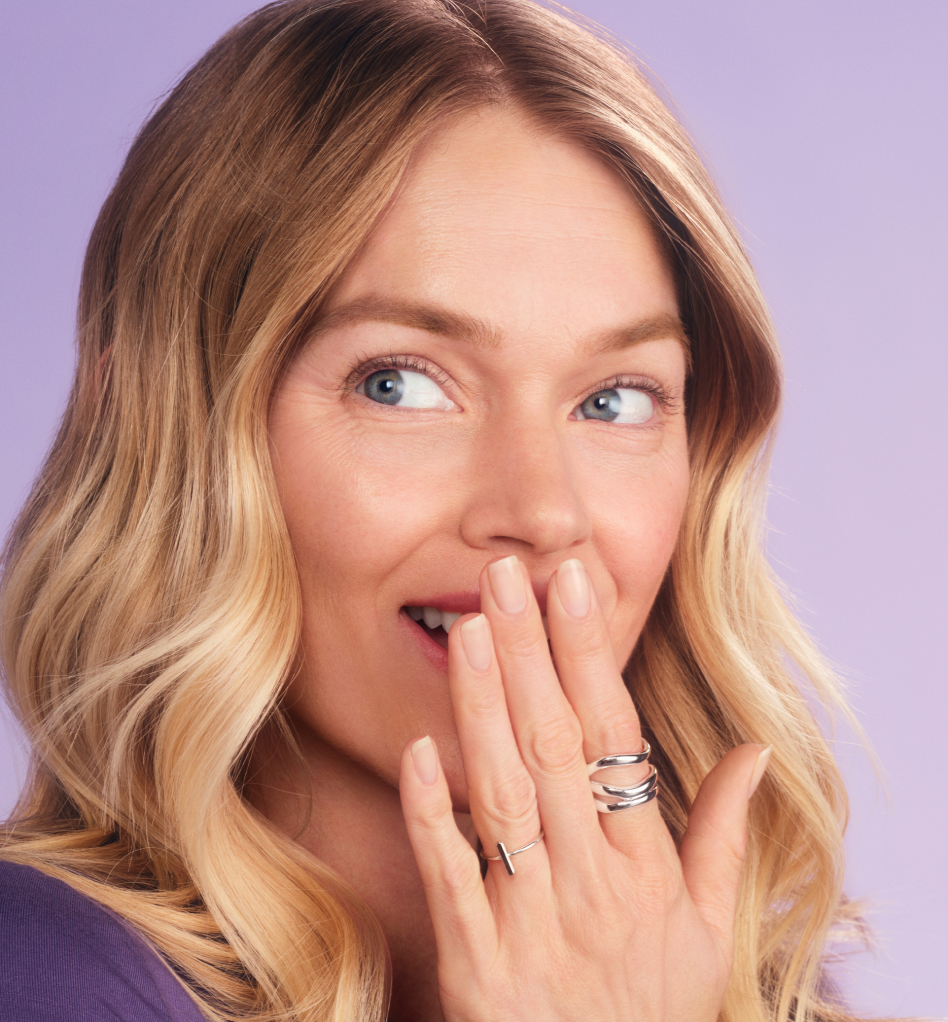 Close up of a man holding Lumify redness relieving eye drops box